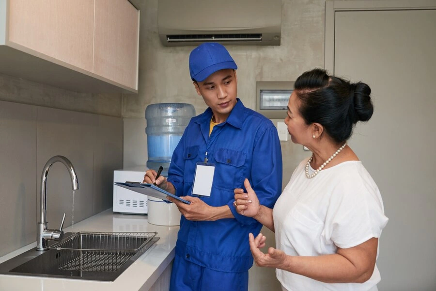 plumber discussing services with client in manchester